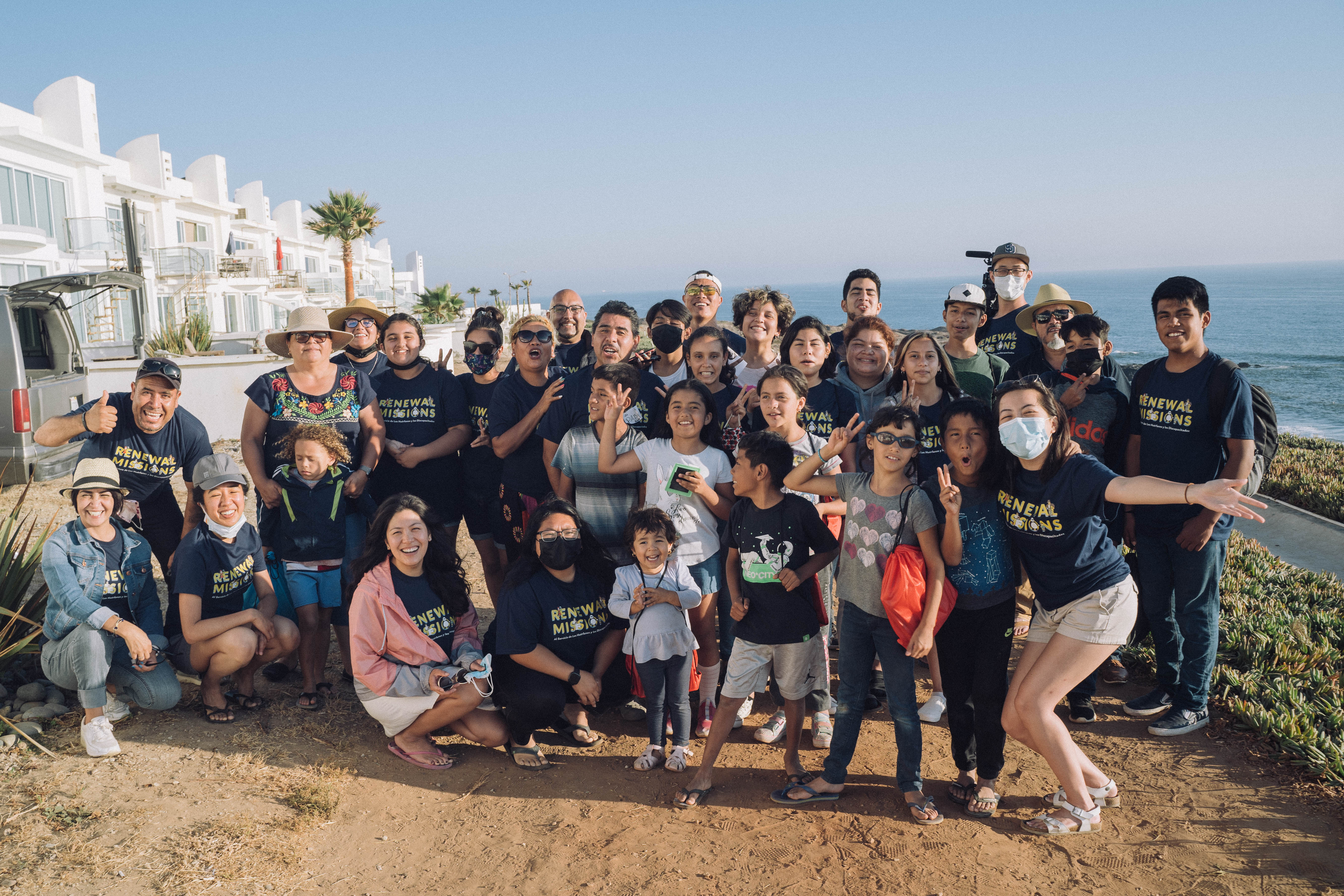 Renewal Missions team and children group photo by the ocean in Tijuana